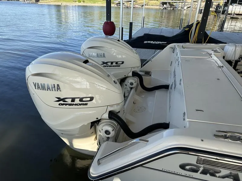 Slide: The Image of 2024 Grady-White Freedom 335 with Yamaha XTO Offshore engines docked by the water. - 15