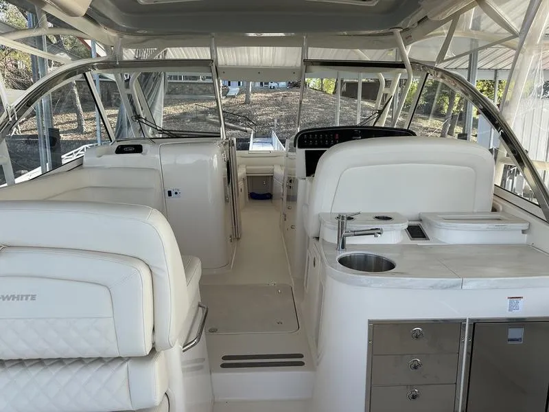 Slide: The Image of 2024 Grady-White Freedom 335 boat interior with white seating and modern amenities. - 2