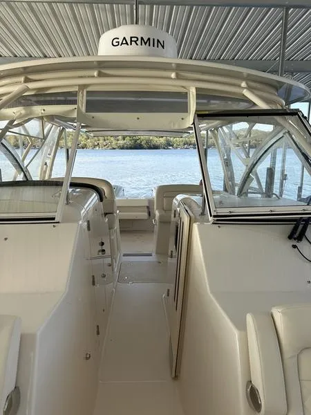 Slide: The Image of 2024 Grady-White Freedom 335 boat interior with Garmin equipment, docked by the water. - 3