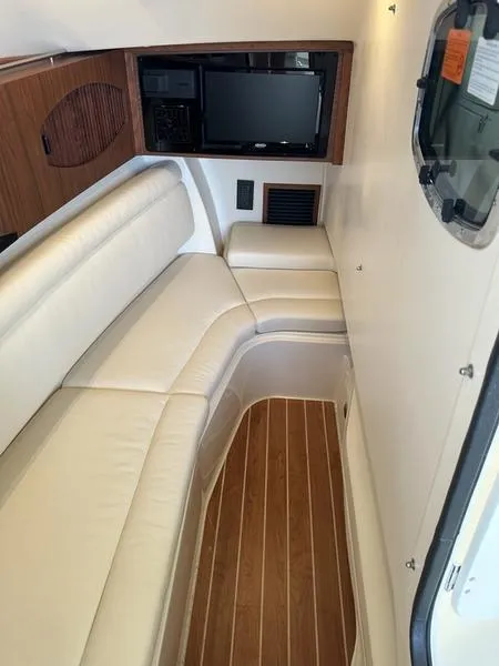 Slide: The Image of 2024 Grady-White Freedom 335 interior with plush seating and wood accents. - 4