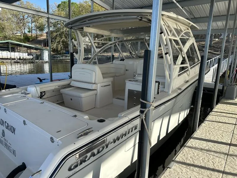 Slide: The Image of 2024 Grady-White Freedom 335 boat docked under a covered marina. - 5