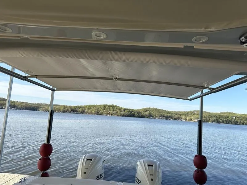 Slide: The Image of 2024 Grady-White Freedom 335 boat with dual engines on a serene lake. - 7