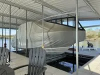 Slide: The Image of 2024 Grady-White Freedom 335 boat covered in a dockside shelter. - 8