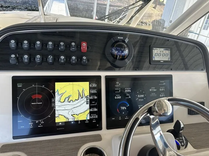 Slide: The Image of 2024 Grady-White Freedom 335 dashboard with navigation and control systems. - 9