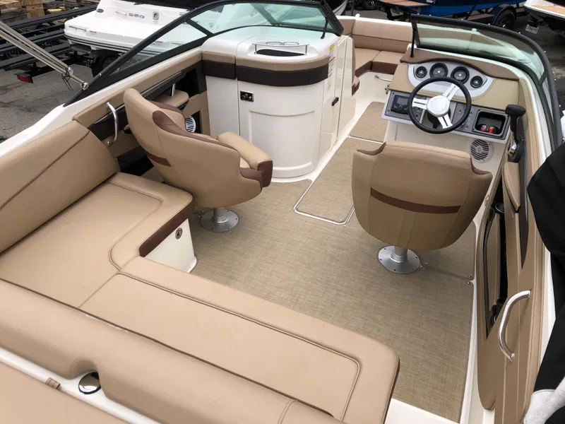 Slide: The Image of 2017 Sea Ray SDX 220 boat interior with beige seating and modern dashboard. - 4