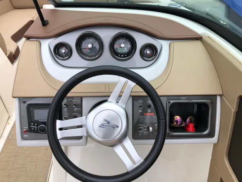 Slide: The Image of 2017 Sea Ray SDX 220 dashboard with steering wheel and instrument panel. - 5