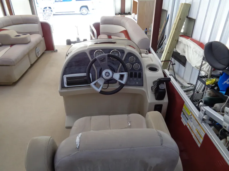 Slide: The Image of Interior of a 2015 Sweetwater 2086 boat with steering console and seating. - 11