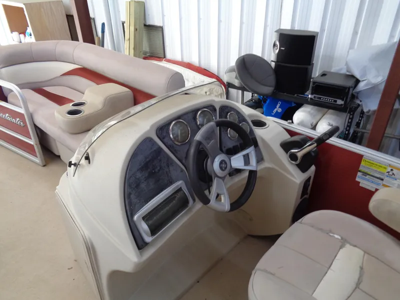 Slide: The Image of Sweetwater 2086 boat interior, 2015 model, featuring steering console and seating area. - 13