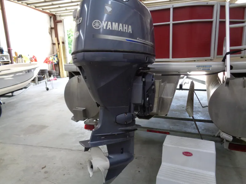 Slide: The Image of Yamaha outboard motor on 2015 Sweetwater 2086 pontoon boat in a garage. - 3
