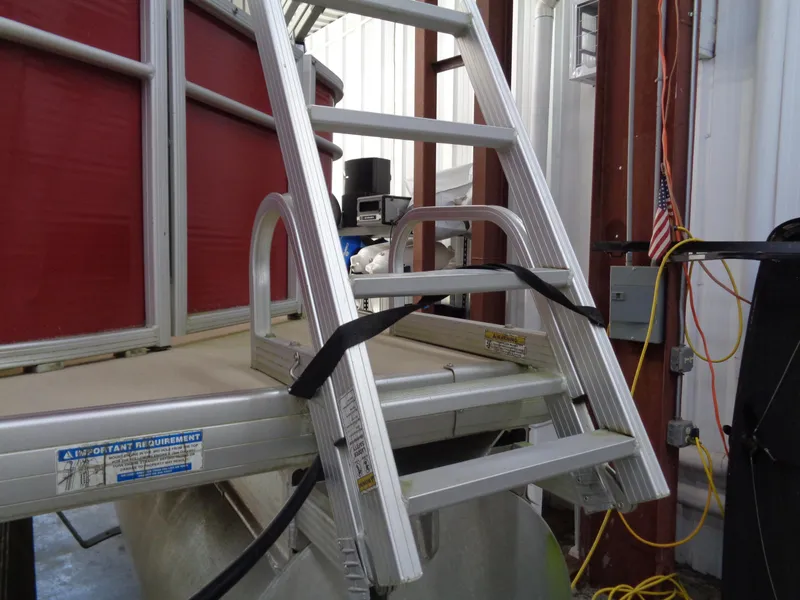 Slide: The Image of Aluminum ladder on Sweetwater 2086 pontoon boat, 2015 model, in a storage facility. - 4