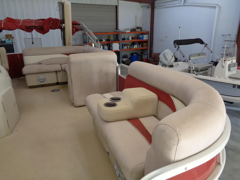 Slide: The Image of Interior of a 2015 Sweetwater 2086 boat with beige and red seating. - 7