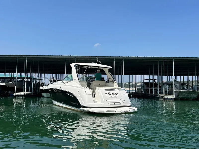 Slide: The Image of 2009 Chaparral 350 Signature boat docked in a marina under clear blue skies. - 10