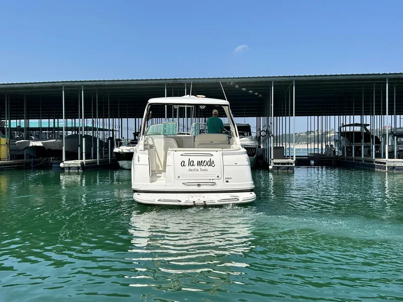Slide: The Image of 2009 Chaparral 350 Signature boat docked in marina, clear blue sky, calm water. - 11