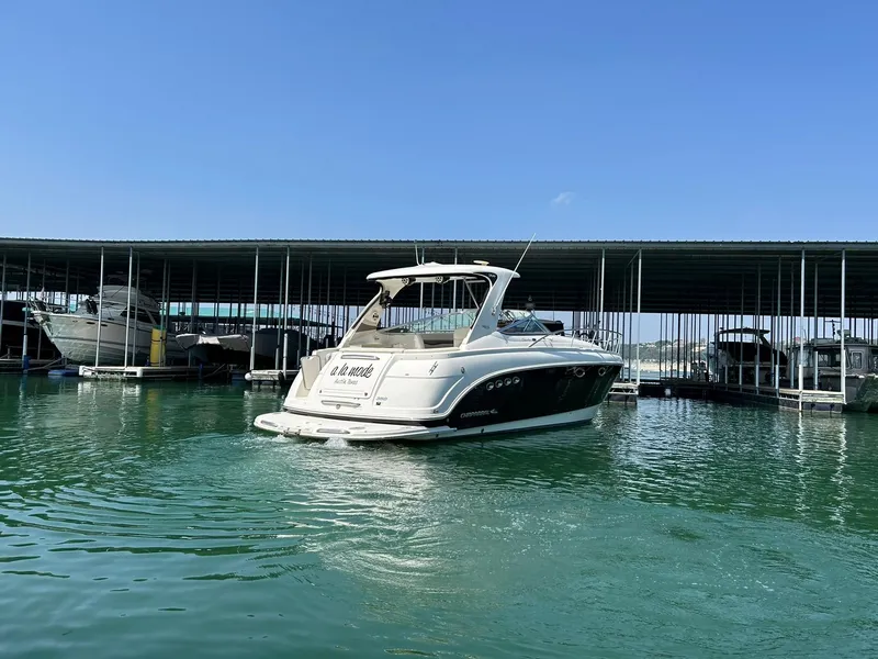 Slide: The Image of 2009 Chaparral 350 Signature boat docked in a marina under clear blue skies. - 13