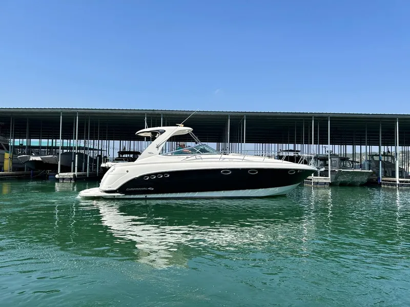 Slide: The Image of 2009 Chaparral 350 Signature boat docked on calm water under clear blue sky. - 15