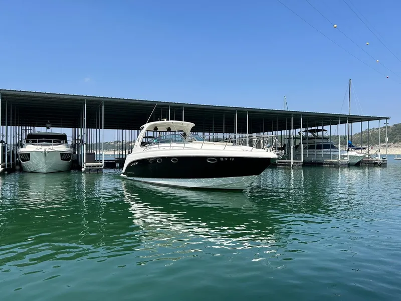 Slide: The Image of 2009 Chaparral 350 Signature boat docked in a marina under a clear blue sky. - 20