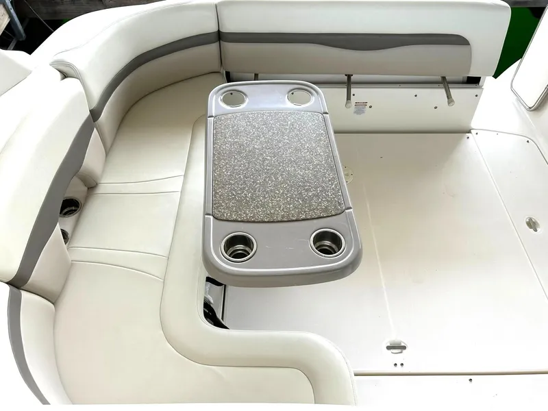Slide: The Image of 2009 Chaparral 350 Signature boat interior with cushioned seating and table with cup holders. - 25