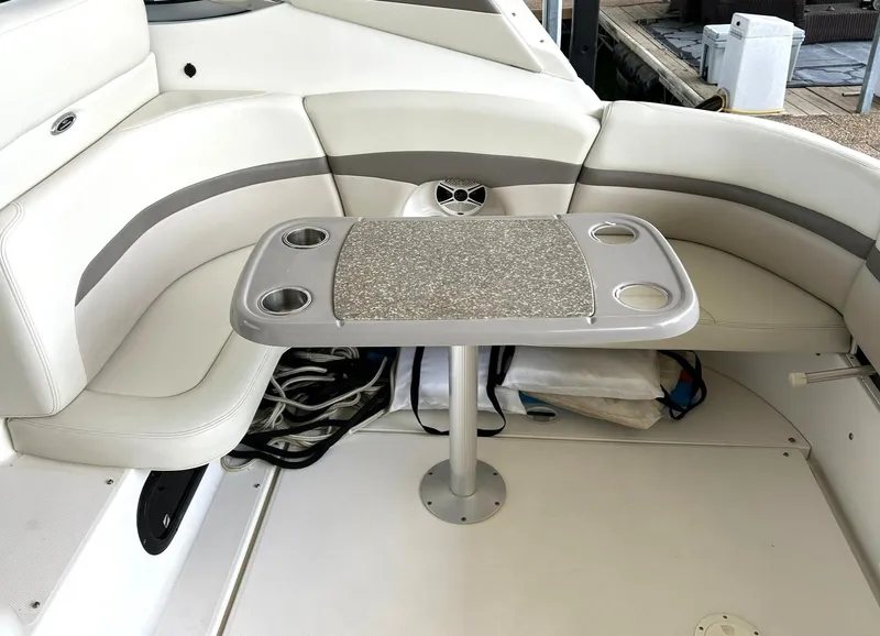 Slide: The Image of 2009 Chaparral 350 Signature boat interior with cushioned seating and table. - 27