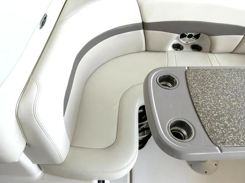 Slide: The Image of 2009 Chaparral 350 Signature boat interior with cushioned seating and table with cup holders. - 28