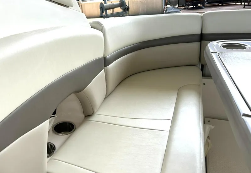 Slide: The Image of 2009 Chaparral 350 Signature boat interior with white leather seating and cup holders. - 29