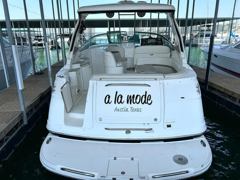 Slide: The Image of 2009 Chaparral 350 Signature boat docked, rear view, "a la mode" text visible. - 3