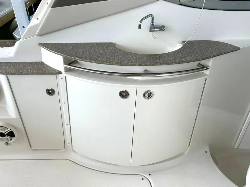 Slide: The Image of 2009 Chaparral 350 Signature boat interior with sink and storage cabinets. - 33