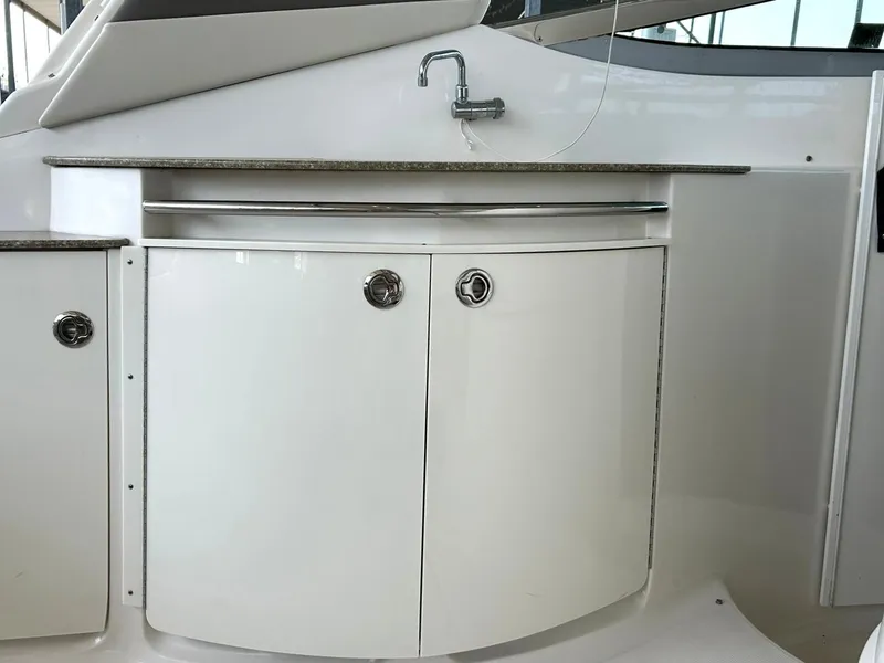 Slide: The Image of 2009 Chaparral 350 Signature yacht kitchenette with sink and storage cabinets. - 34