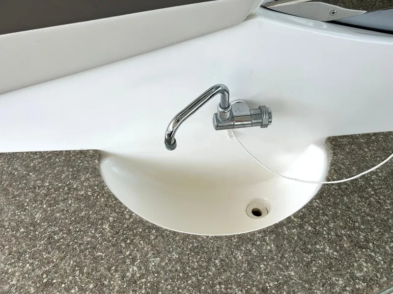 Slide: The Image of 2009 Chaparral 350 Signature boat sink with chrome faucet on a textured countertop. - 35