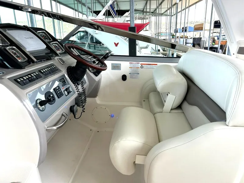 Slide: The Image of 2009 Chaparral 350 Signature boat cockpit with white seating and modern dashboard controls. - 40