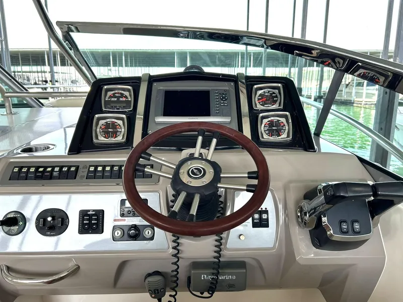 Slide: The Image of 2009 Chaparral 350 Signature boat dashboard with steering wheel and control panel. - 41