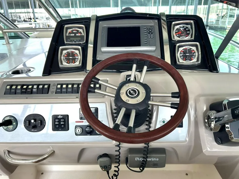 Slide: The Image of 2009 Chaparral 350 Signature boat dashboard with steering wheel and navigation controls. - 42