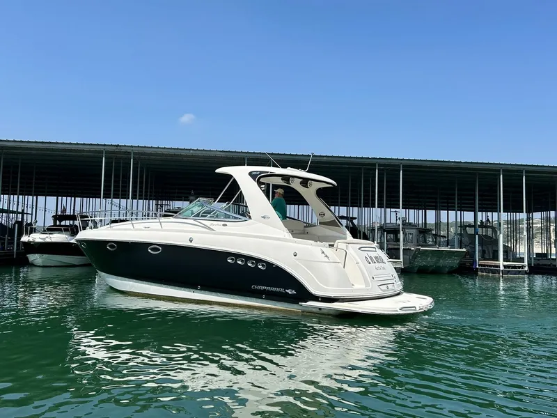 Slide: The Image of 2009 Chaparral 350 Signature boat docked on calm water under clear blue sky. - 8