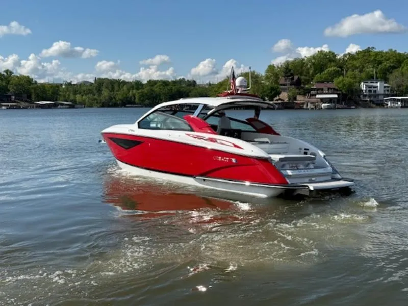 Slide: The Image of 2022 Cobalt A36BR boat in vibrant red on a serene lake. - 11