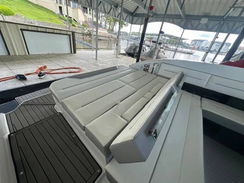 Slide: The Image of 2022 Cobalt A36BR boat interior with spacious seating under a covered dock. - 23