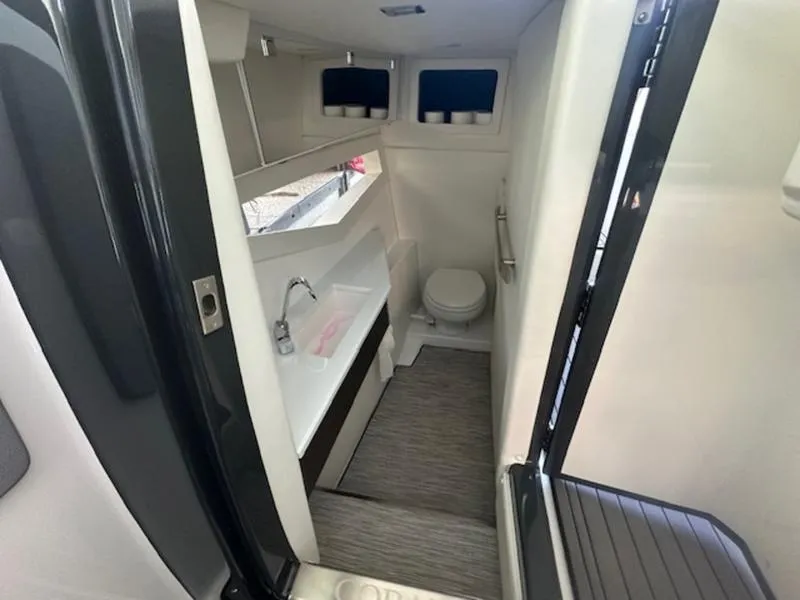 Slide: The Image of 2022 Cobalt A36BR boat interior bathroom with sink, toilet, and modern design. - 27