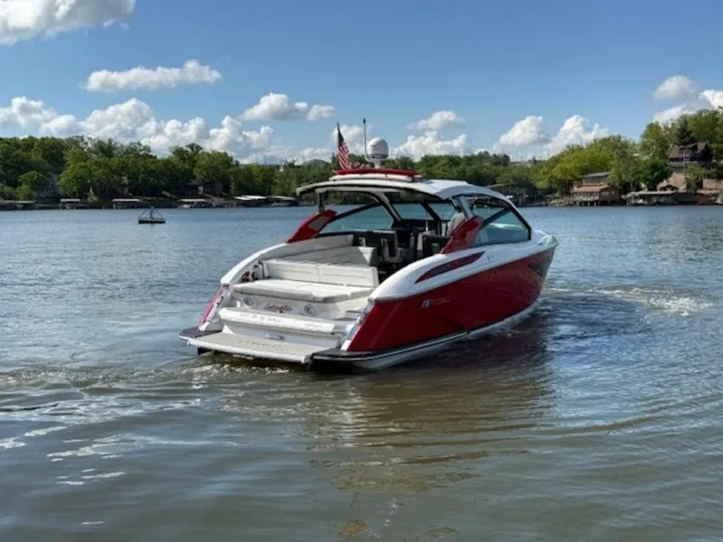 Slide: The Image of Red 2022 Cobalt A36BR boat cruising on a lake under a clear blue sky. - 3