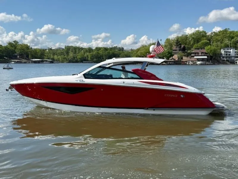 Slide: The Image of 2022 Cobalt A36BR boat on a lake, red and white design, sunny day, American flag. - 4