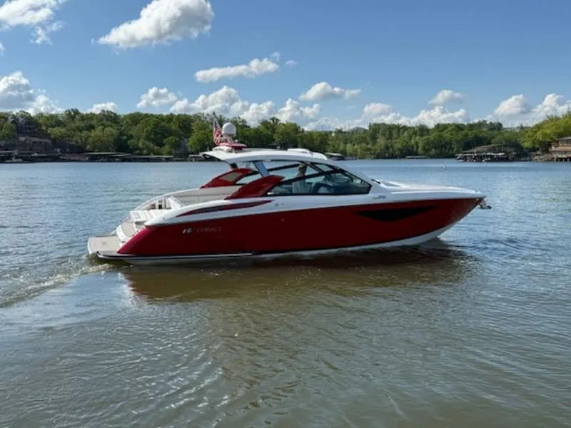 Slide: The Image of 2022 Cobalt A36BR boat on a calm lake under a clear blue sky. - 6