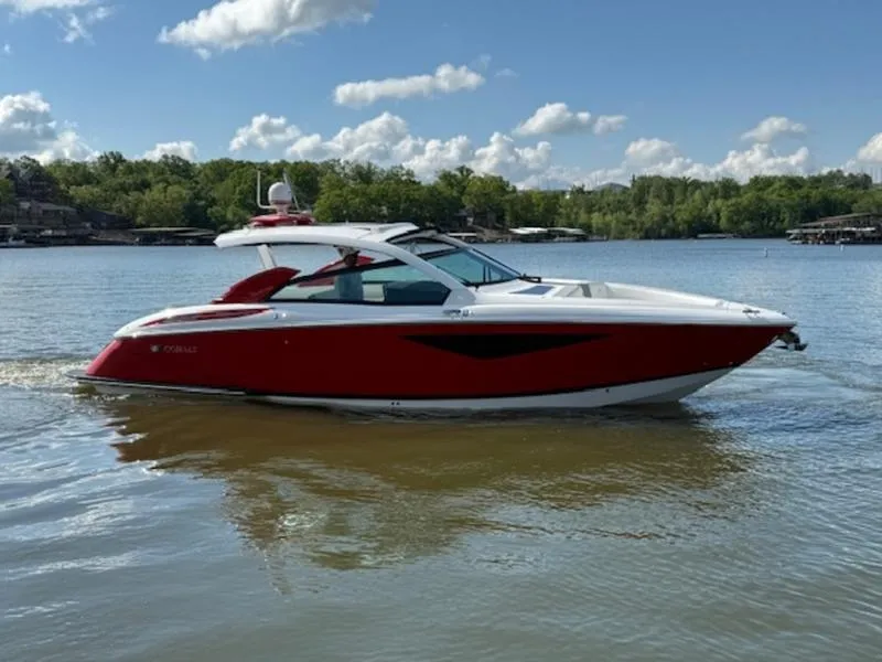 Slide: The Image of 2022 Cobalt A36BR boat on a calm lake under a partly cloudy sky. - 9