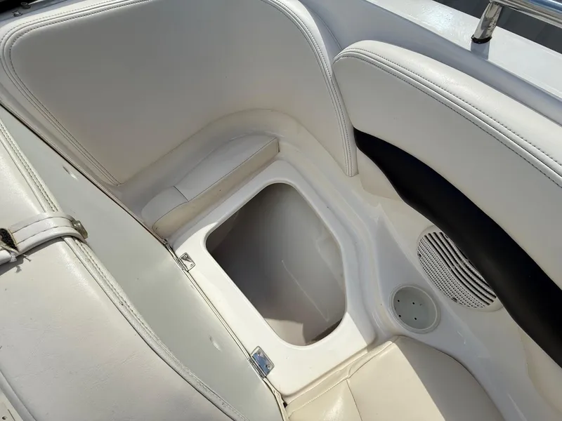 Slide: The Image of Interior seating and storage of 2000 Chaparral 196 SSi boat, featuring white upholstery. - 10