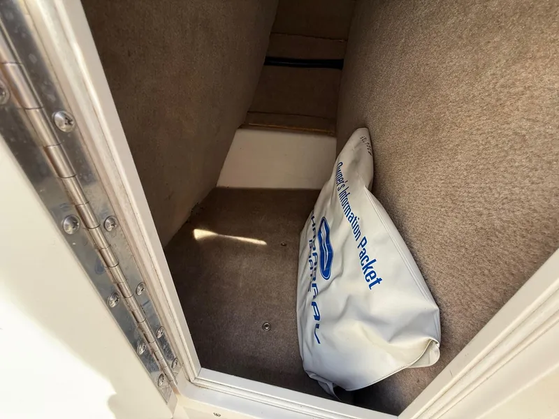 Slide: The Image of Interior storage compartment of 2000 Chaparral 196 SSi boat with information packet. - 11