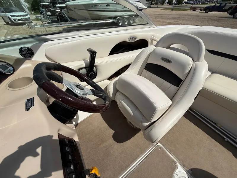 Slide: The Image of Interior of a 2000 Chaparral 196 SSi boat with steering wheel and seating. - 14