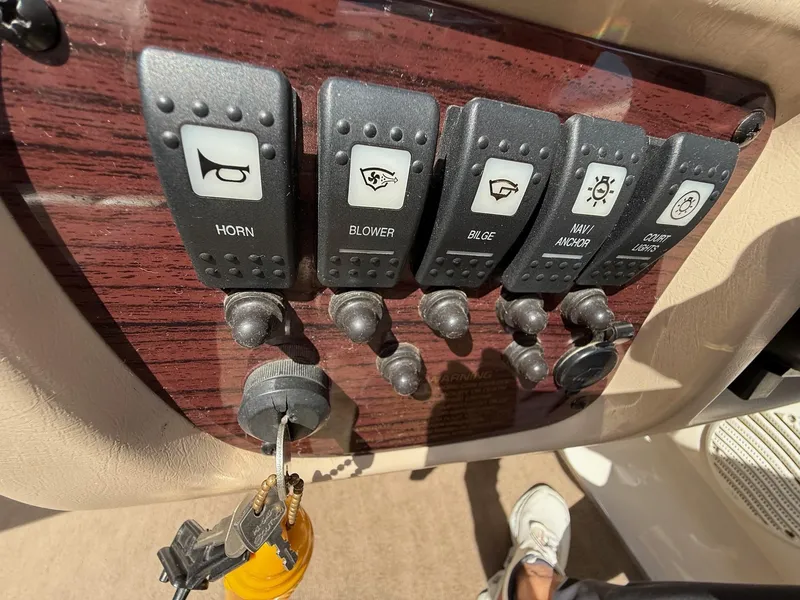 Slide: The Image of Control panel of a 2000 Chaparral 196 SSi boat with labeled switches and keys. - 15