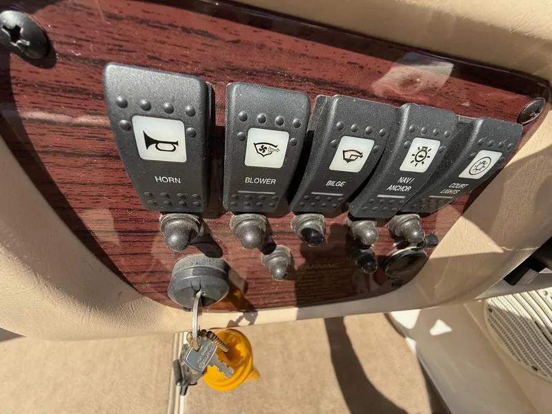 Slide: The Image of Control panel of a 2000 Chaparral 196 SSi boat with labeled switches and keys. - 18