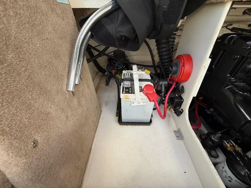 Slide: The Image of Battery compartment of a 2000 Chaparral 196 SSi boat, featuring wiring and components. - 24