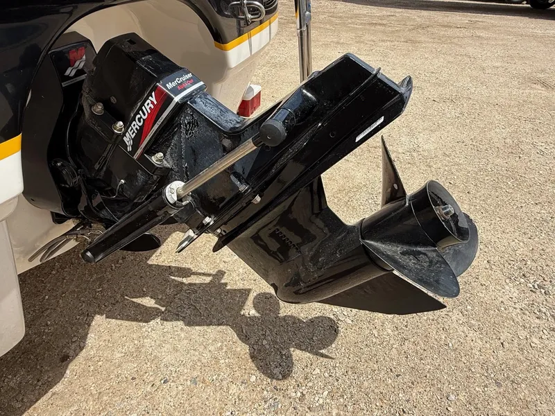 Slide: The Image of 2000 Chaparral 196 SSi boat with Mercury MerCruiser Alpha One outdrive on gravel surface. - 4