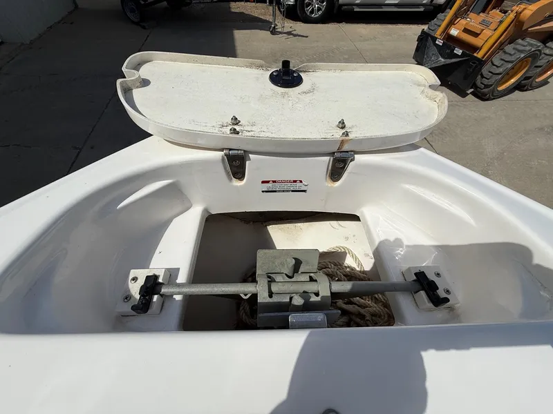 Slide: The Image of Open storage compartment on a 2000 Chaparral 196 SSi boat, showing anchor and rope. - 9