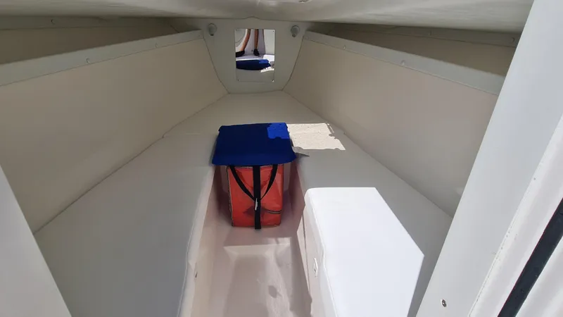 Slide: The Image of Interior cabin of a 2005 Marlago FS35 boat, featuring a compact, minimalist design. - 11