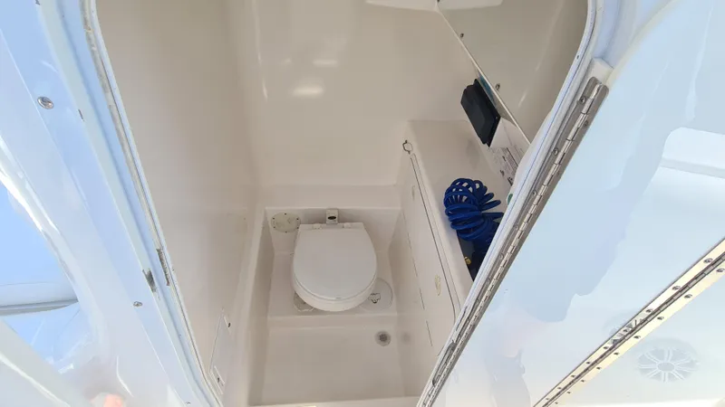 Slide: The Image of 2005 Marlago FS35 boat interior with compact marine toilet and storage. - 13