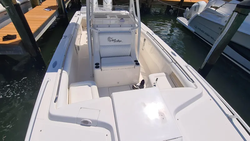 Slide: The Image of 2005 Marlago FS35 boat docked, showcasing spacious deck and seating area. - 14